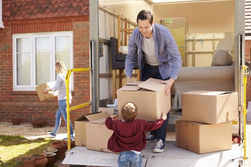 Man and van service loading items into a moving vehicle