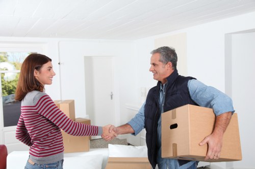 Professional movers packing boxes for a Watford relocation